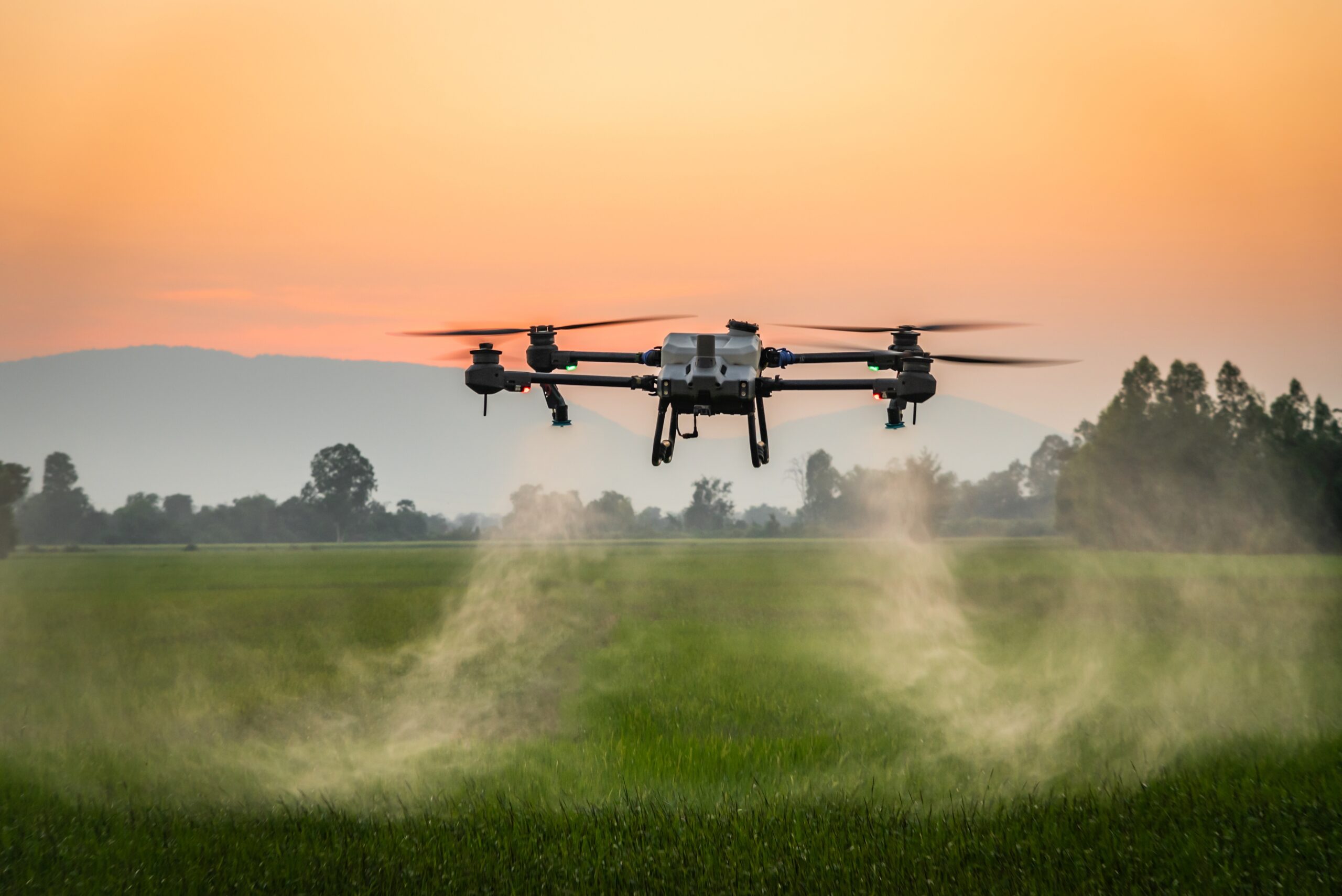 Agricultural drone spraying a field